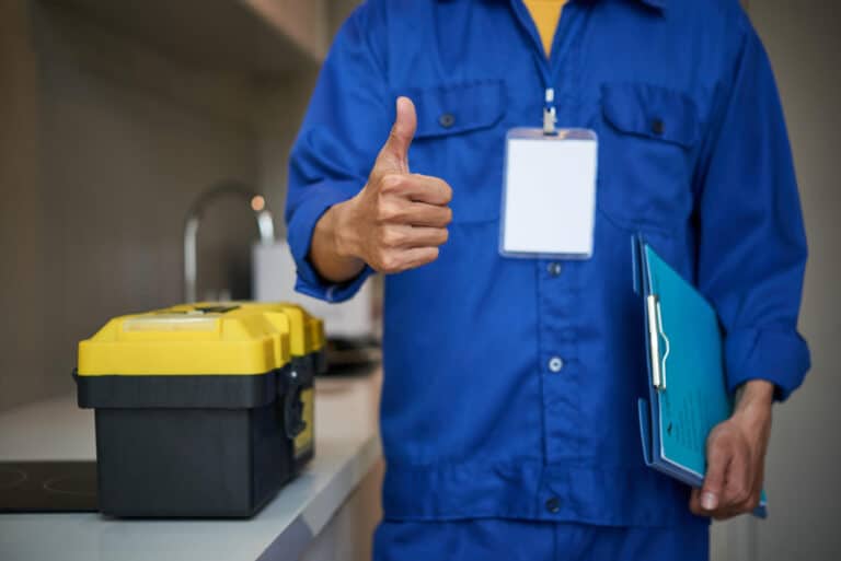 unrecognizable-male-plumber-standing-near-kitchen-sink-showing-thumb-up (1)