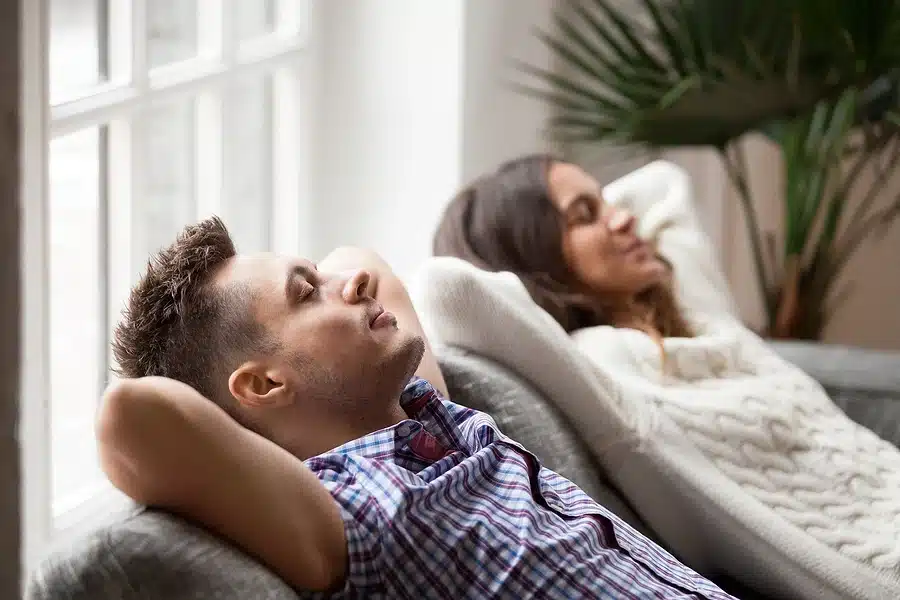 Couple resting on couch