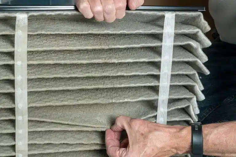Person looking at AC air filter