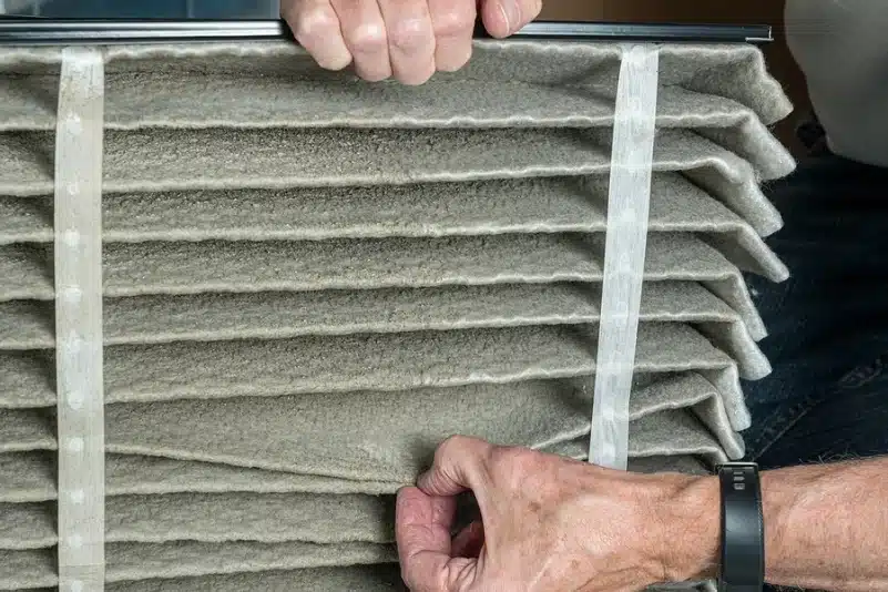 Person looking at AC air filter