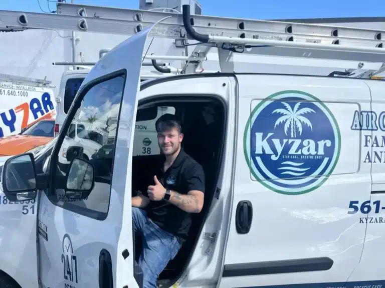 Kyzar AC technician in branded van giving the thumbs up sign.